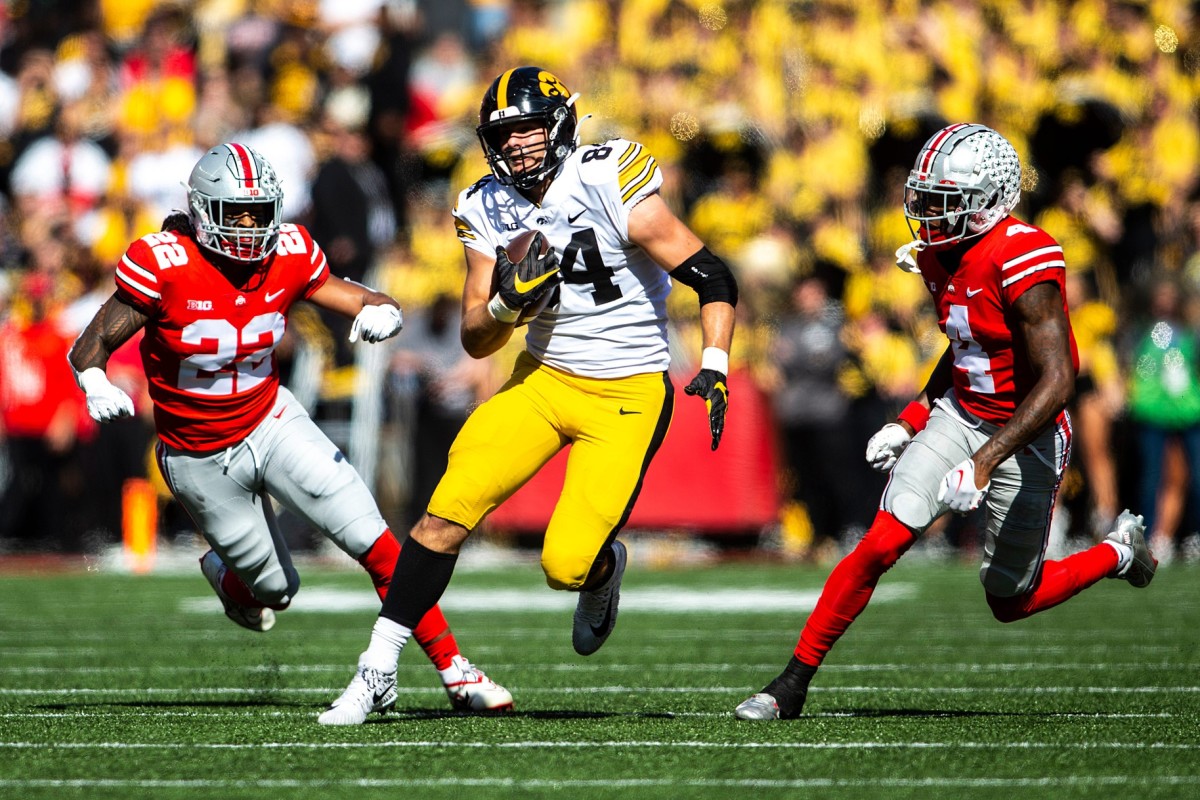 Iowa tight end Sam LaPorta (84) runs for extra yards as Ohio State linebacker Steele Chambers (22) and Ohio State cornerback JK Johnson (4) give chase. Joseph Cress/Iowa City Press-Citizen / USA TODAY NETWORK